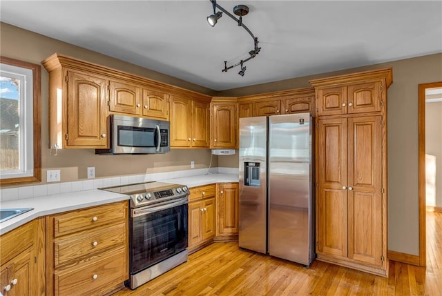 kitchen featuring light hardwood / wood-style flooring and stainless steel appliances