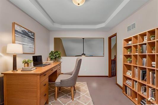 office space featuring radiator, a raised ceiling, and concrete floors