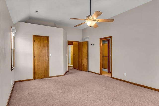 unfurnished bedroom featuring vaulted ceiling, light colored carpet, and ceiling fan