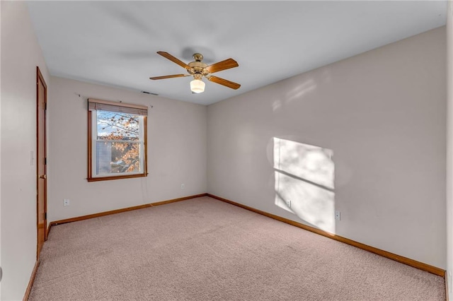 unfurnished room with ceiling fan and light colored carpet