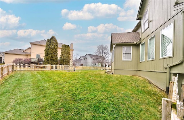 view of yard featuring a fenced backyard and a residential view