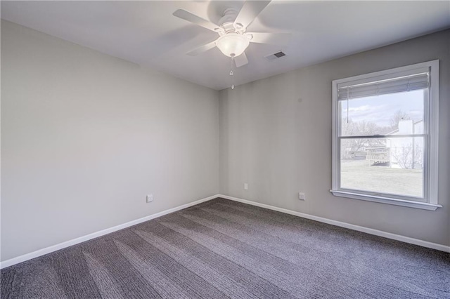 carpeted spare room with visible vents, ceiling fan, and baseboards