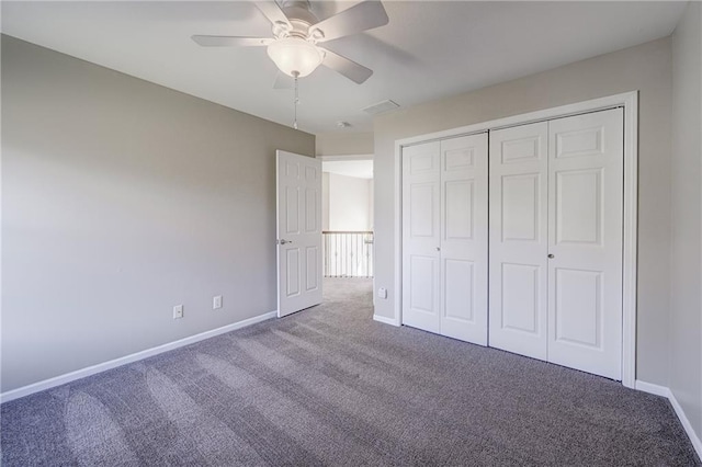 unfurnished bedroom with carpet floors, a closet, baseboards, and a ceiling fan