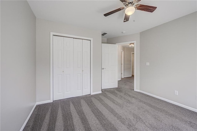 unfurnished bedroom with carpet, a closet, visible vents, and baseboards