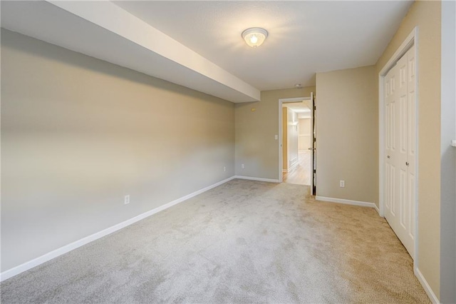 unfurnished bedroom with carpet floors, a closet, and baseboards