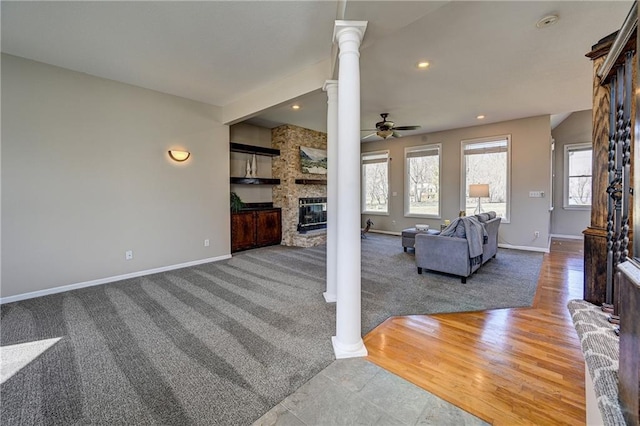 living area featuring a fireplace, decorative columns, recessed lighting, a ceiling fan, and baseboards