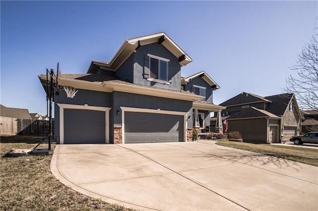 view of front of home featuring stone siding, stucco siding, driveway, and fence