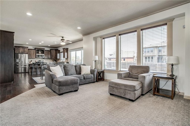 living room with recessed lighting, baseboards, ceiling fan, and dark wood-style flooring