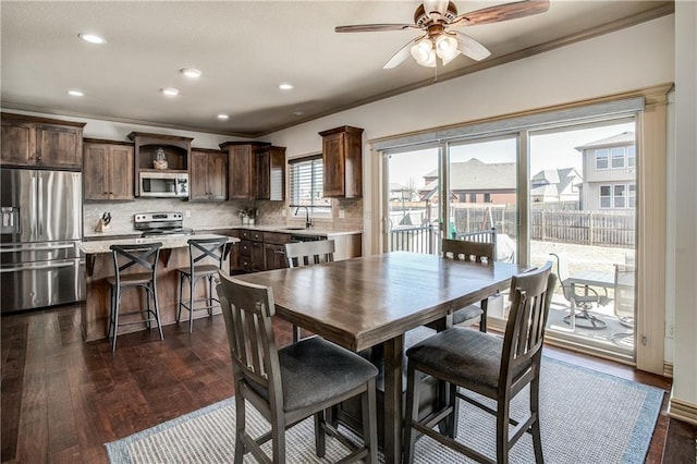 dining room featuring recessed lighting, dark wood-type flooring, ornamental molding, and ceiling fan