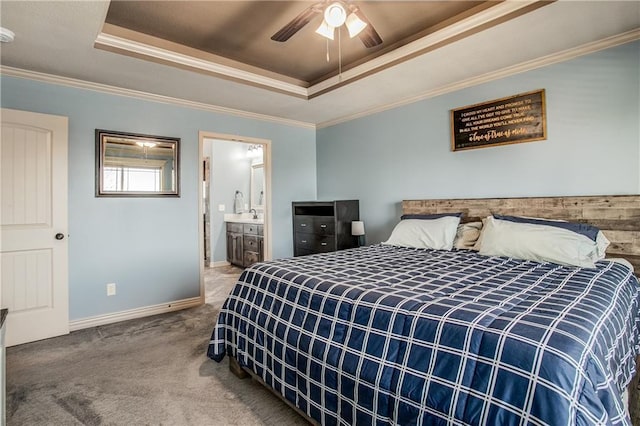 bedroom featuring a tray ceiling, baseboards, ornamental molding, and carpet flooring