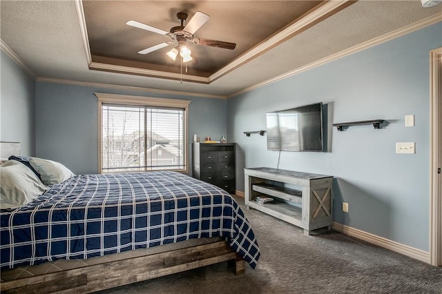 bedroom featuring crown molding, a raised ceiling, baseboards, and carpet floors