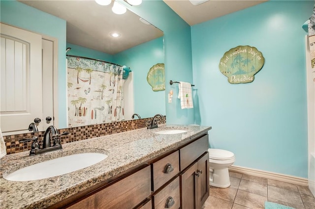 full bath featuring a sink, decorative backsplash, toilet, and tile patterned floors