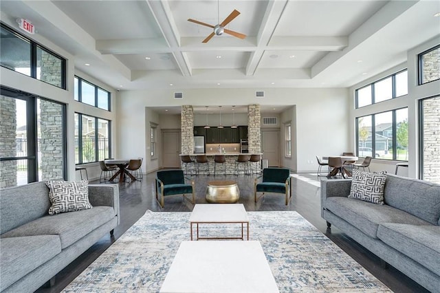 living room with baseboards, coffered ceiling, beam ceiling, a high ceiling, and recessed lighting