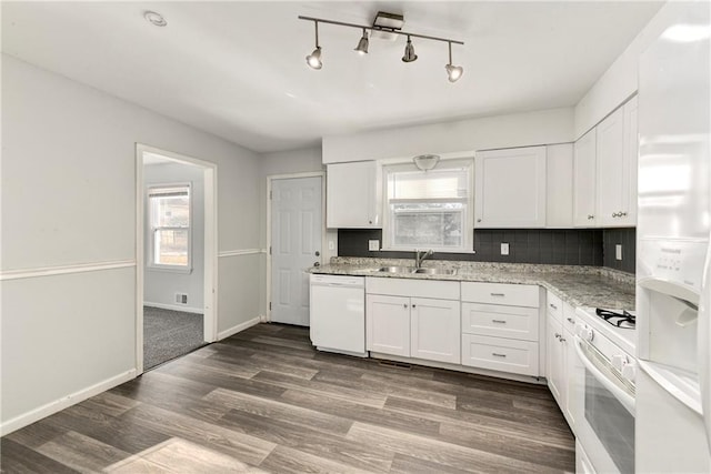 kitchen featuring white appliances, backsplash, sink, white cabinetry, and dark hardwood / wood-style floors