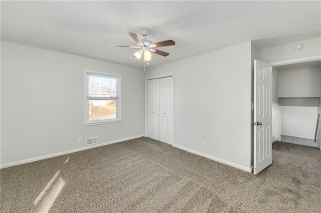 unfurnished bedroom featuring ceiling fan, carpet, and a closet