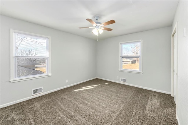 unfurnished bedroom featuring dark carpet and ceiling fan