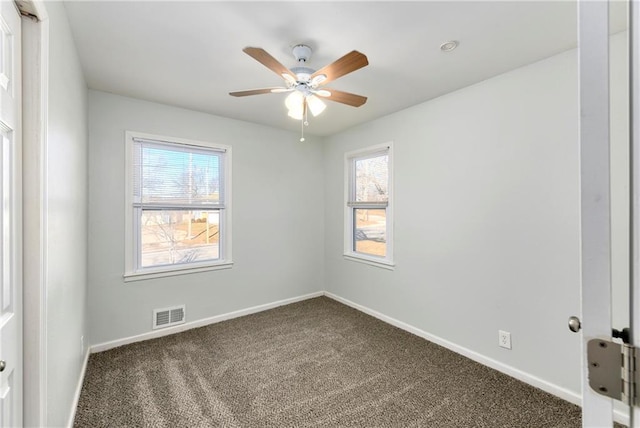 carpeted spare room with ceiling fan