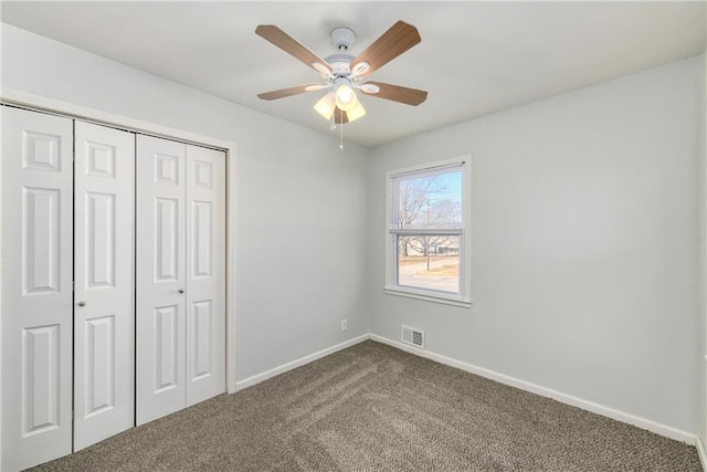 unfurnished bedroom with a closet, ceiling fan, and carpet floors