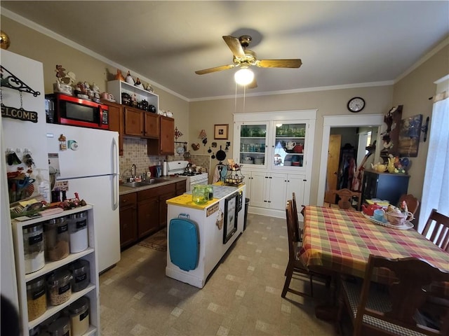 513 S Business Highway 13, Lexington, MO 64067 - kitchen with white appliances, a sink, a ceiling fan, crown molding, and backsplash