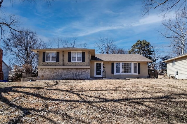 split level home featuring stucco siding