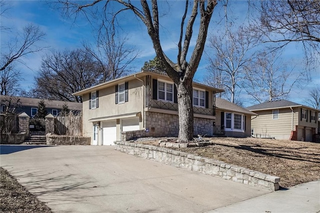 view of front of house featuring an attached garage, stone siding, concrete driveway, and stucco siding