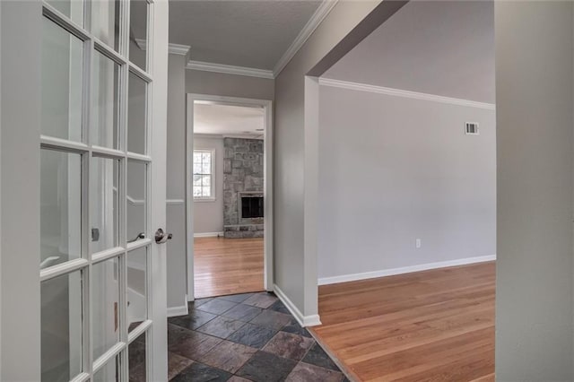 7924 Roe Ave, Prairie Village, KS 66208 - hall with crown molding, baseboards, stone tile flooring, and visible vents