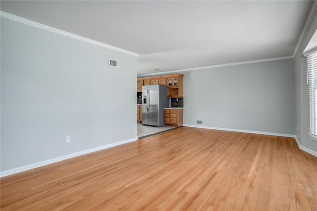 7924 Roe Ave, Prairie Village, KS 66208 - unfurnished living room featuring baseboards, ornamental molding, light wood-style flooring, and visible vents