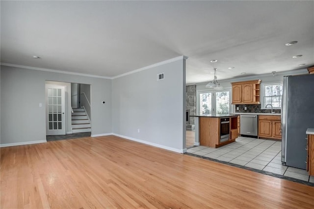 7924 Roe Ave, Prairie Village, KS 66208 - kitchen featuring light wood-type flooring, open shelves, appliances with stainless steel finishes, and visible vents