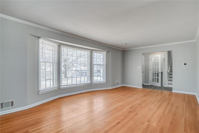 7924 Roe Ave, Prairie Village, KS 66208 - spare room with crown molding, light wood-style flooring, baseboards, visible vents, and stairway