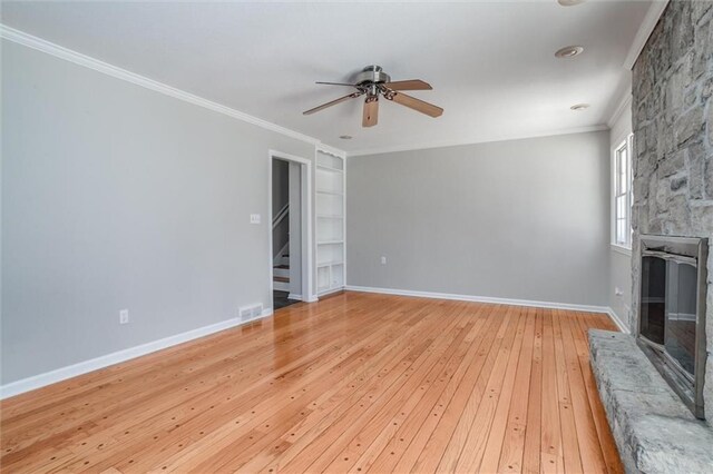 7924 Roe Ave, Prairie Village, KS 66208 - unfurnished living room with ceiling fan, light wood-style floors, a fireplace, built in shelves, and ornamental molding