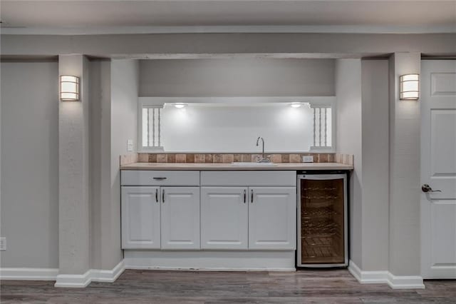 7924 Roe Ave, Prairie Village, KS 66208 - bar featuring indoor wet bar, a sink, wine cooler, and wood finished floors