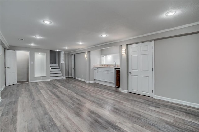 7924 Roe Ave, Prairie Village, KS 66208 - unfurnished living room with baseboards, recessed lighting, stairs, and wood finished floors
