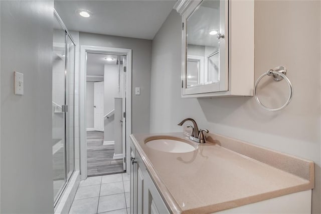 7924 Roe Ave, Prairie Village, KS 66208 - bathroom featuring vanity, tile patterned flooring, and a stall shower