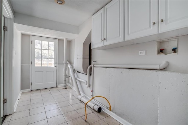 7924 Roe Ave, Prairie Village, KS 66208 - clothes washing area with light tile patterned floors, washer hookup, baseboards, and cabinet space