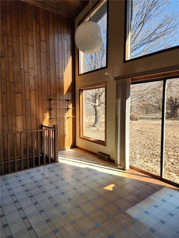 11425 45th Hwy N, Platte City, MO 64079 - entrance foyer with a towering ceiling, wooden walls, tile patterned floors, wood ceiling, and baseboards