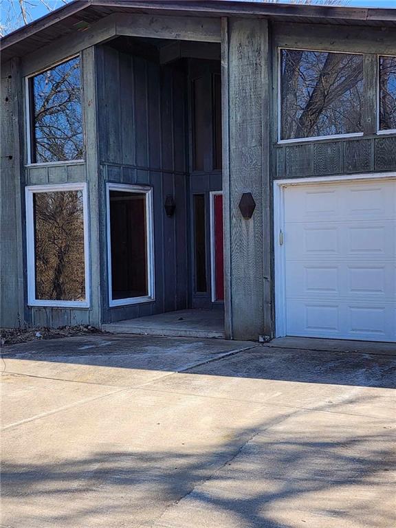 11425 45th Hwy N, Platte City, MO 64079 - property entrance featuring a garage and concrete driveway