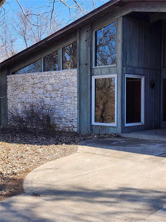 11425 45th Hwy N, Platte City, MO 64079 - view of exterior entry with stone siding and a patio