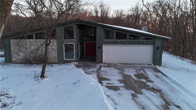 11425 45th Hwy N, Platte City, MO 64079 - mid-century modern home featuring concrete driveway and an attached garage