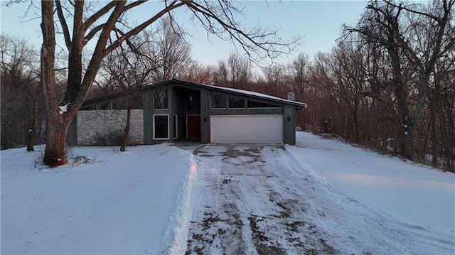 11425 45th Hwy N, Platte City, MO 64079 - view of front of home featuring an attached garage, stone siding, and driveway