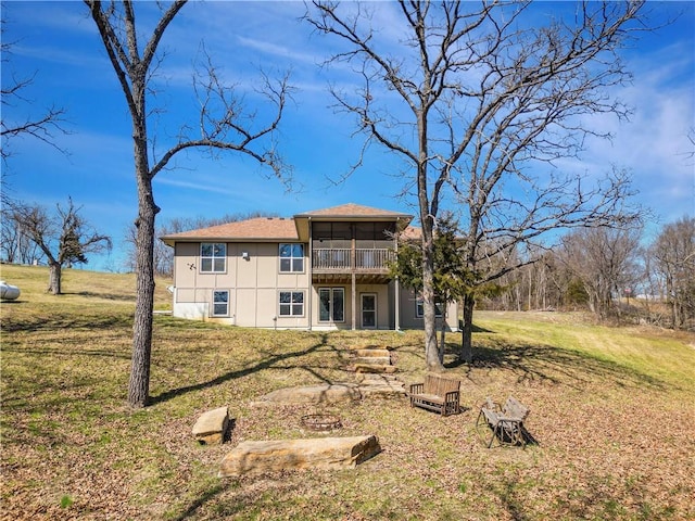 rear view of property featuring a yard and a sunroom