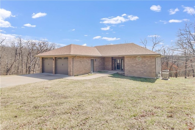 single story home featuring brick siding, a front lawn, roof with shingles, a garage, and driveway