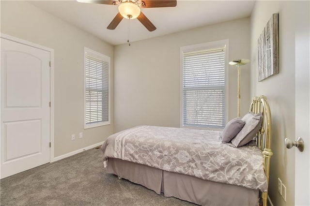 carpeted bedroom featuring baseboards and ceiling fan