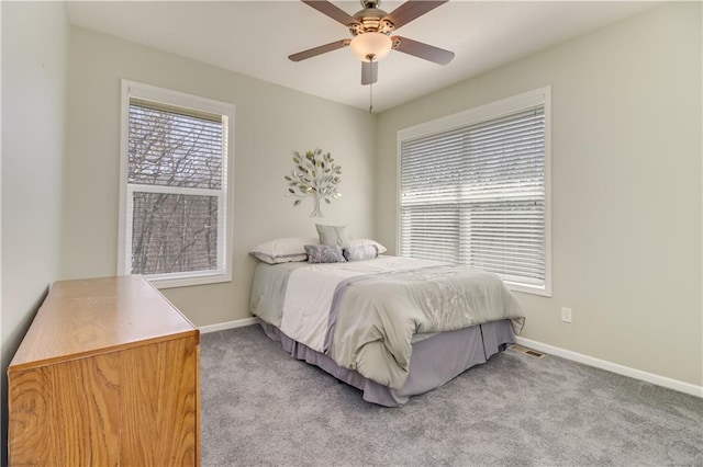 bedroom featuring light carpet, ceiling fan, and baseboards