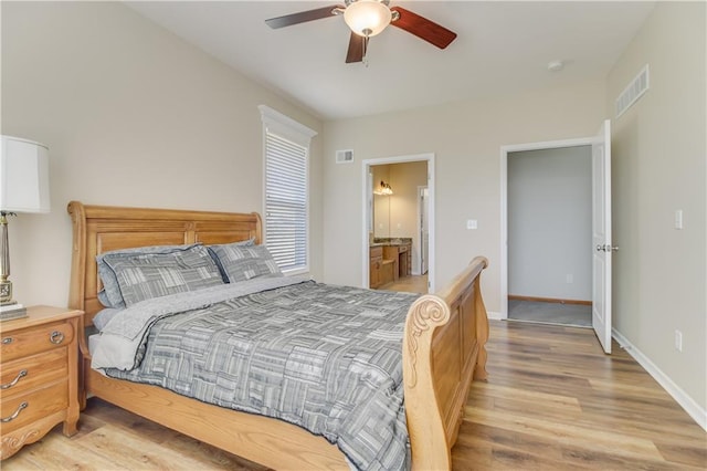 bedroom featuring visible vents, ceiling fan, light wood-type flooring, and baseboards