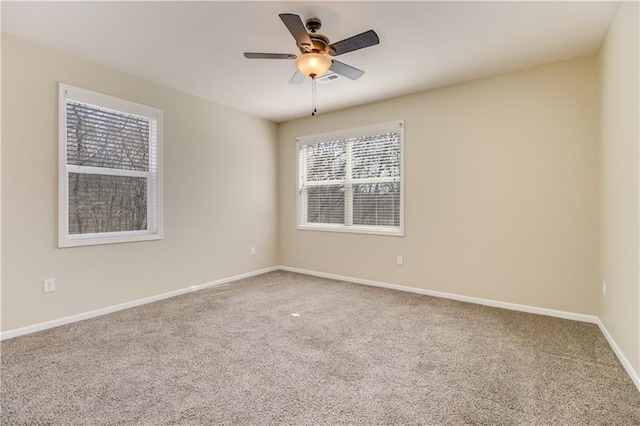 unfurnished room with baseboards, ceiling fan, and carpet flooring