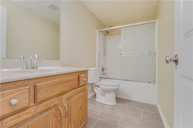 full bath with visible vents, toilet, tile patterned flooring, bath / shower combo with glass door, and vanity