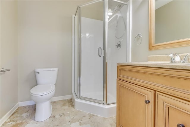 bathroom featuring baseboards, vanity, toilet, and a shower stall