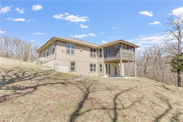 rear view of property with a patio area and a sunroom