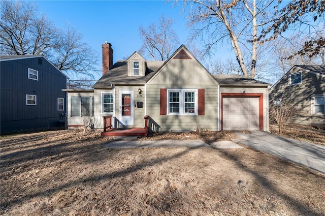 view of front of property featuring driveway, a chimney, and an attached garage