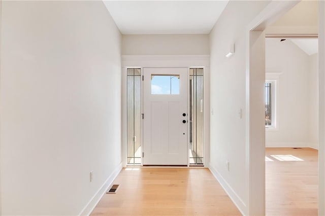 entryway with light hardwood / wood-style floors